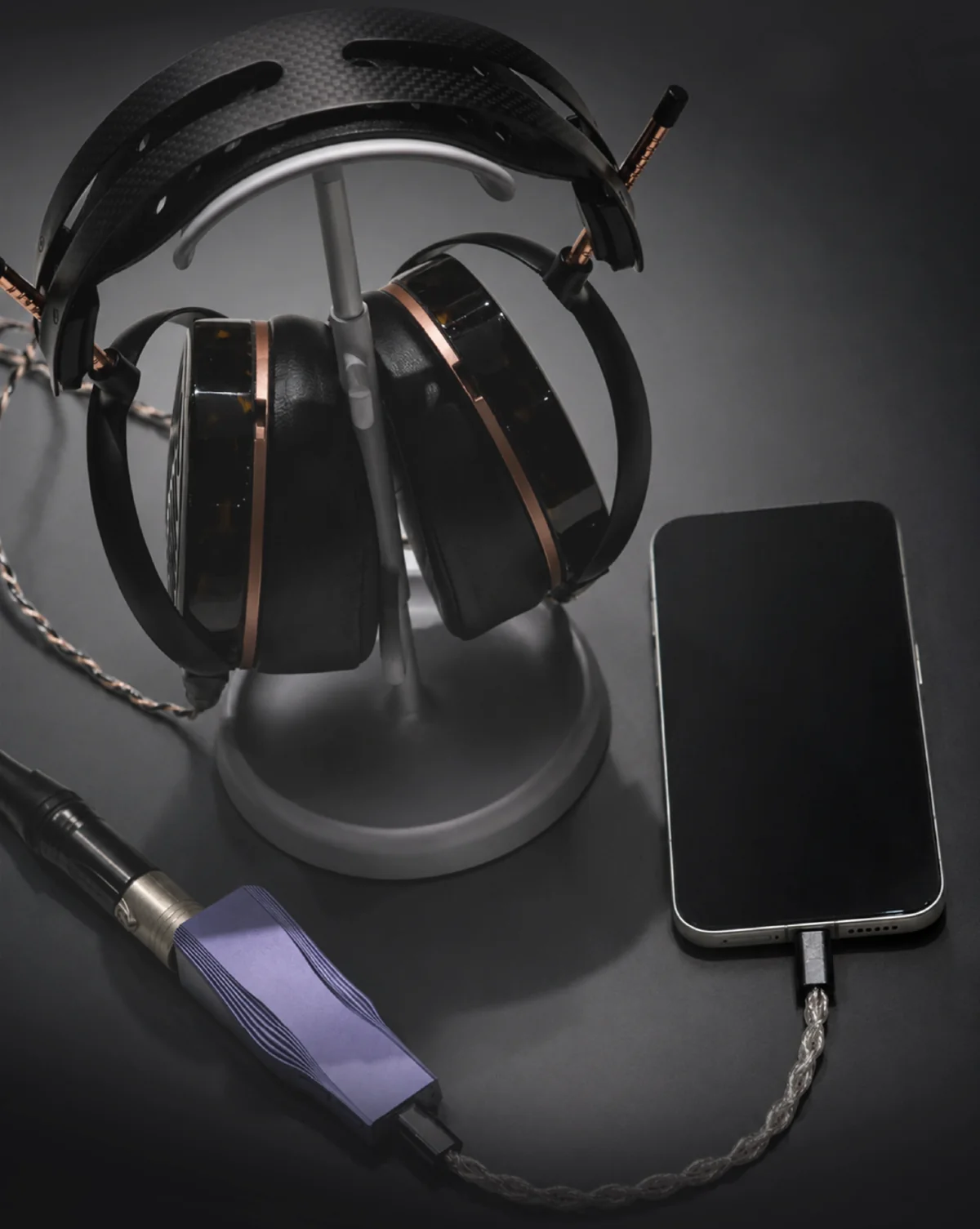 OPERA connected between a phone and a pair of over-ear headphones